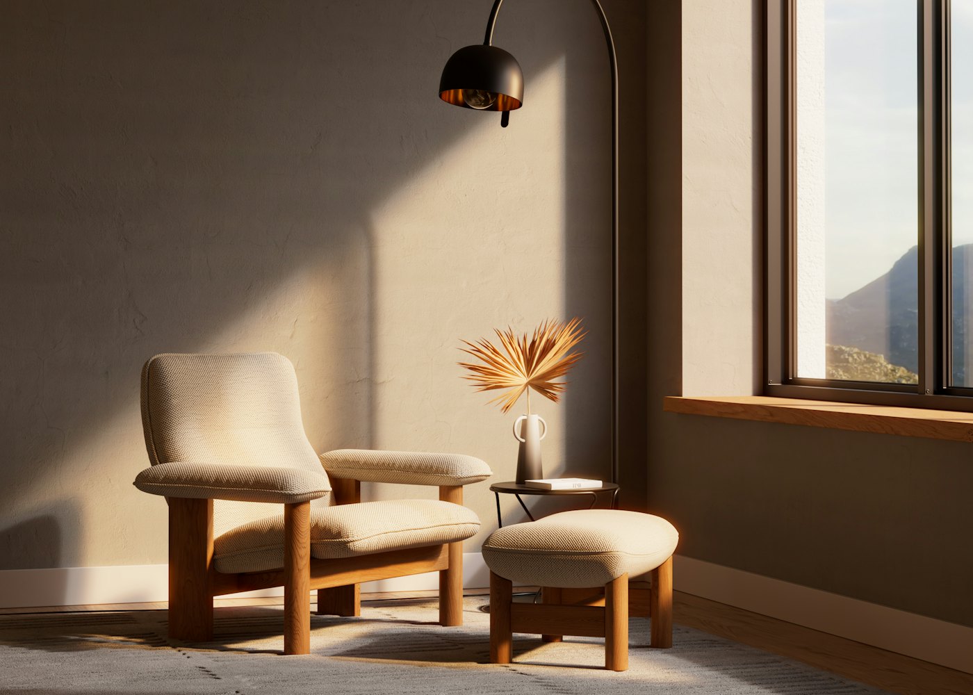 Oak-framed lounge chair and matching ottoman in oatmeal bouclé, beside a window in late afternoon light