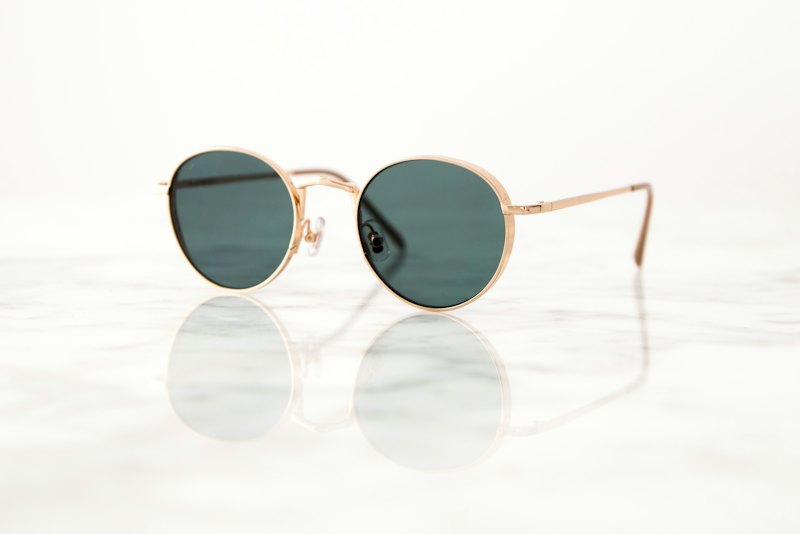 Teluk round sunglasses in gold titanium with bottle-green lenses